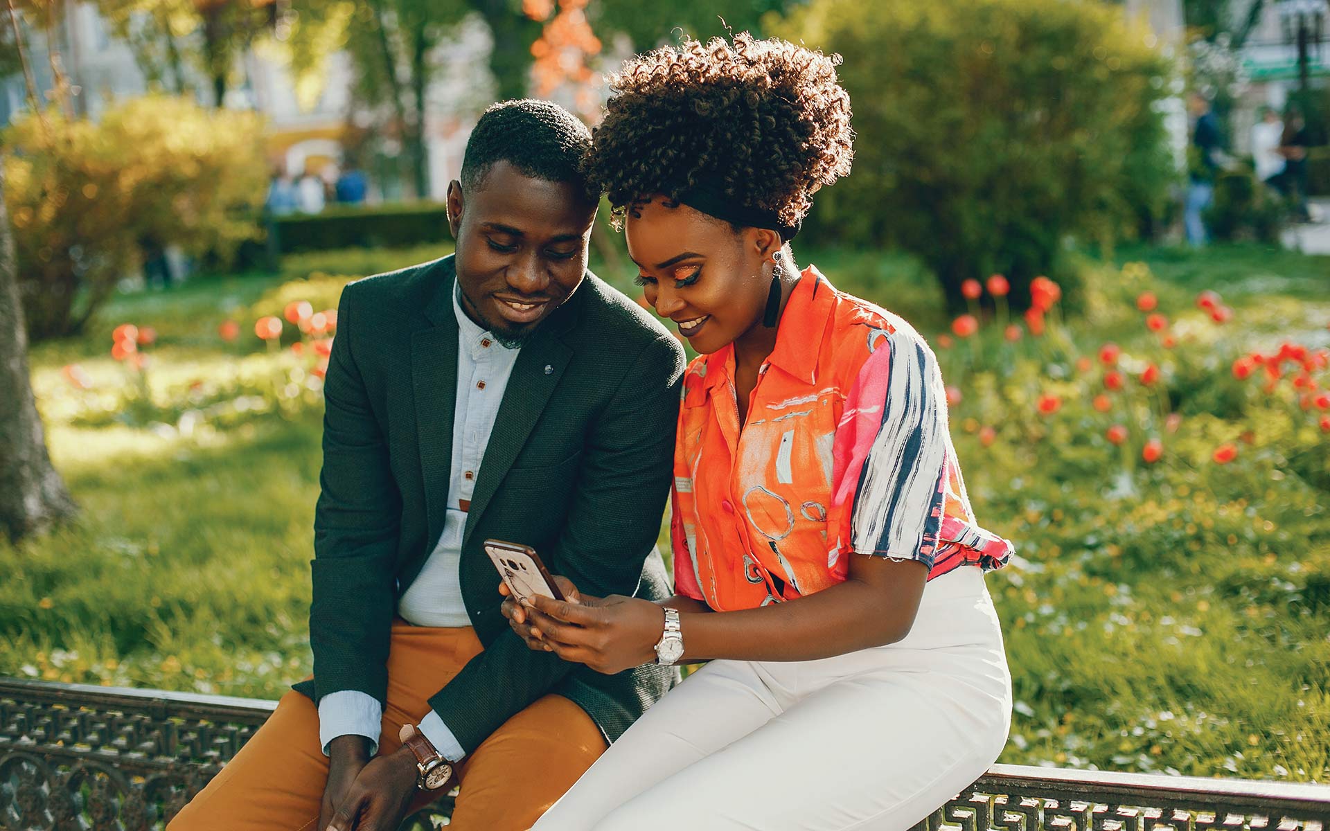 A beautiful young lady showing her spouse her business page on the phone